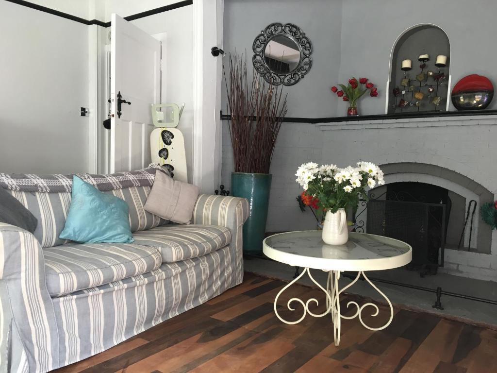 Hazelwick sitting room with striped sofa and fireplace